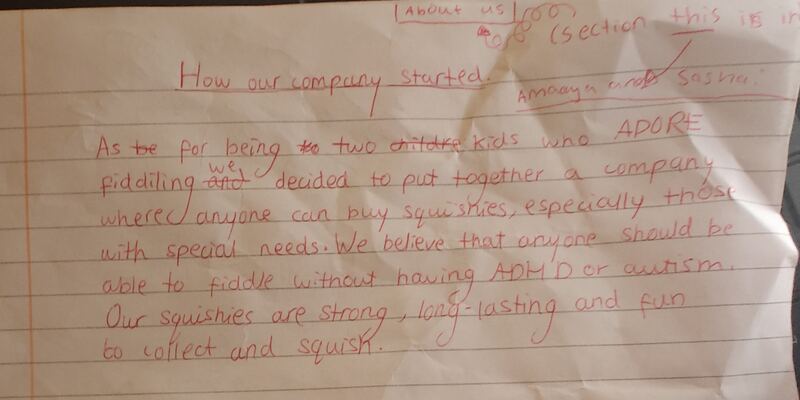 The original handwritten 'How our company started' page, written in red pen by Amaaya and Sasha.
